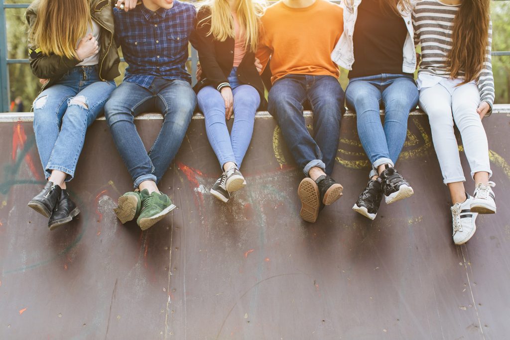 young group sitting on wall